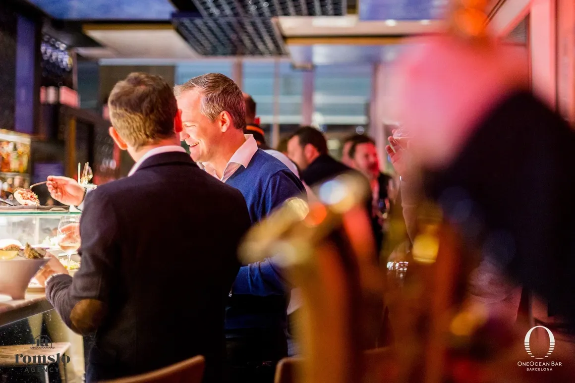 Guests enjoying a social event at a bar, featuring live saxophone music by Romslo Entertainment