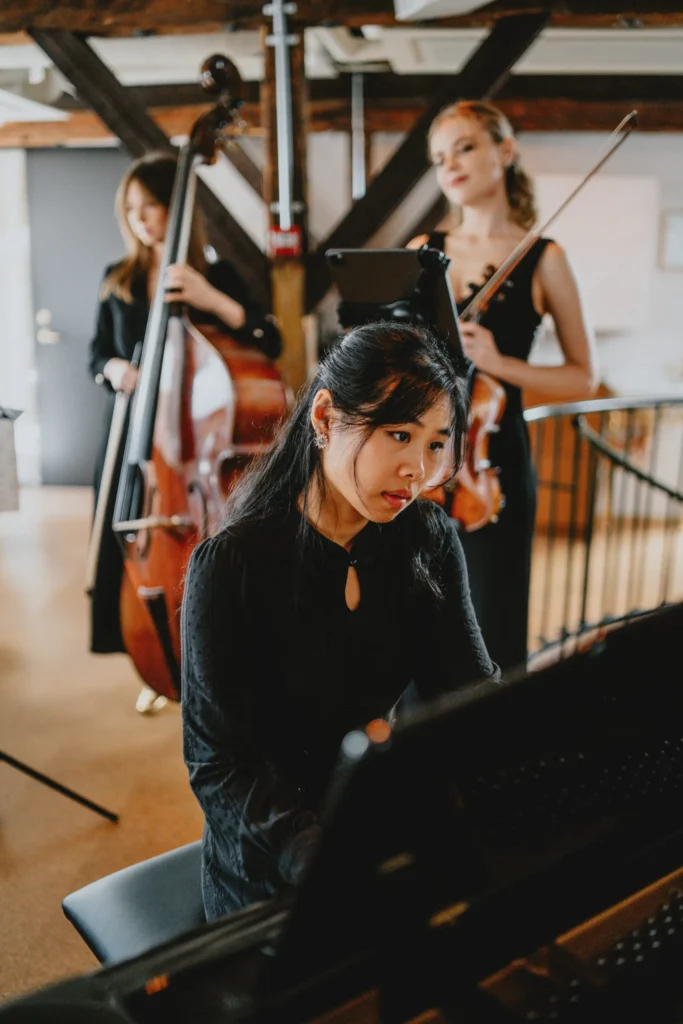 A band of three girls performing at a memorial event.