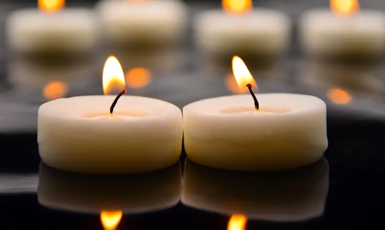 Burning candles at a memorial service, creating a serene atmosphere.