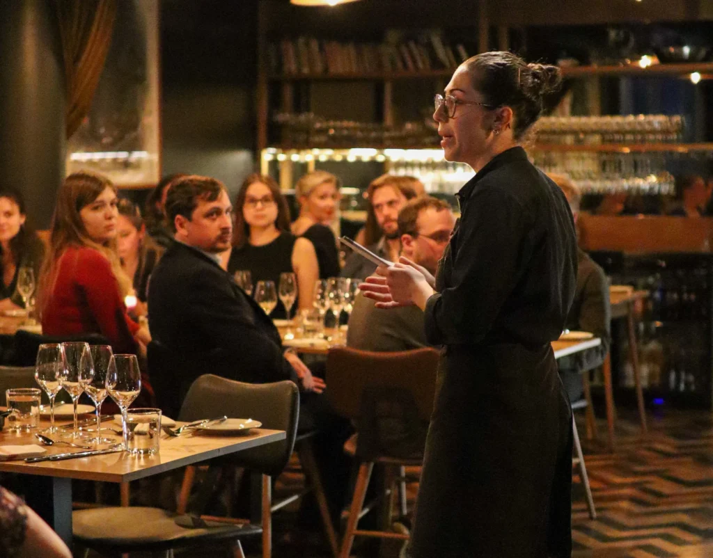 A speaker addressing an audience while attendees listen attentively.