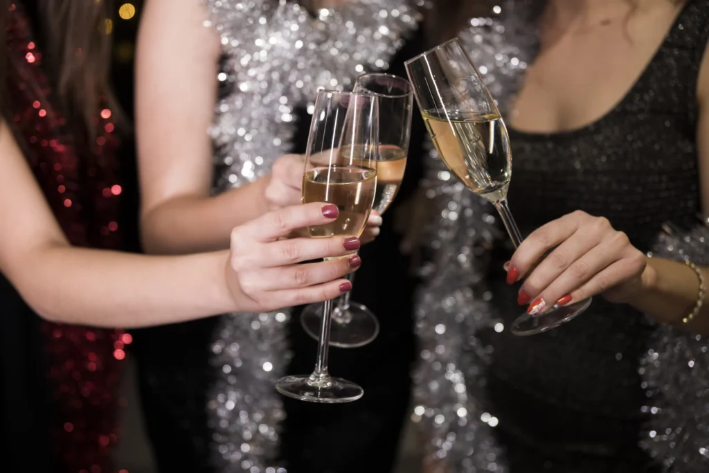 Girls toasting with champagne at a New Year’s party.