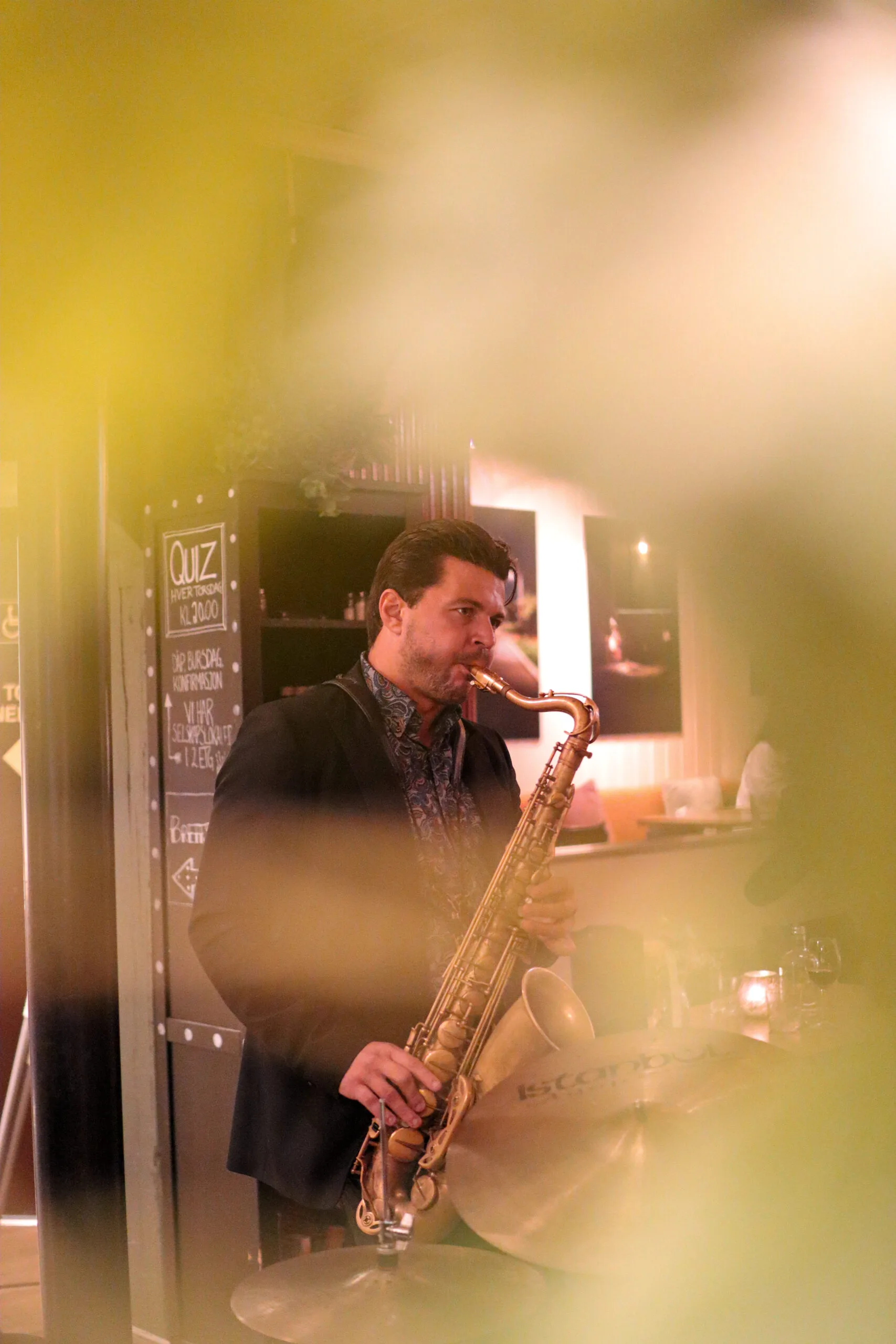 Johan, saxophonist from Romslo Entertainment, performing live at a cozy indoor venue in Norway.